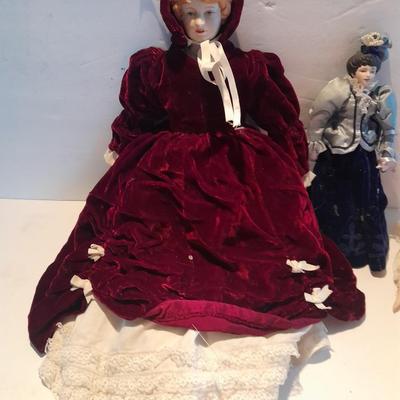 Three porcelain face and footed dolls Cloth bodied.
