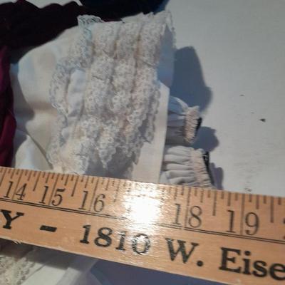 Three porcelain face and footed dolls Cloth bodied.