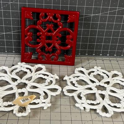 3 Cast Iron Trivets 2 White and 1 Red.