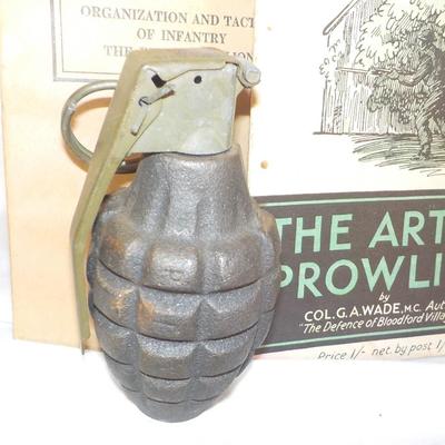 WW1 and WW2 Combat Training Books and a Display Grenade (Empty) est. $25 to$55.