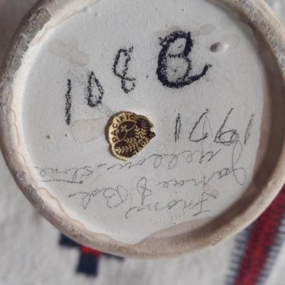 Pacific pottery vase with Native American print table throw.