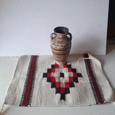 Pacific pottery vase with Native American print table throw.