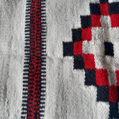 Pacific pottery vase with Native American print table throw.