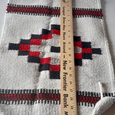 Pacific pottery vase with Native American print table throw.