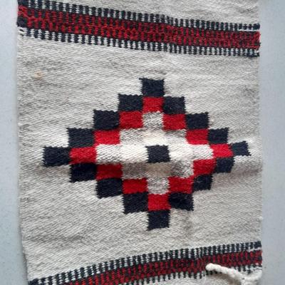 Pacific pottery vase with Native American print table throw.