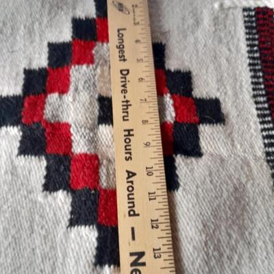 Pacific pottery vase with Native American print table throw.