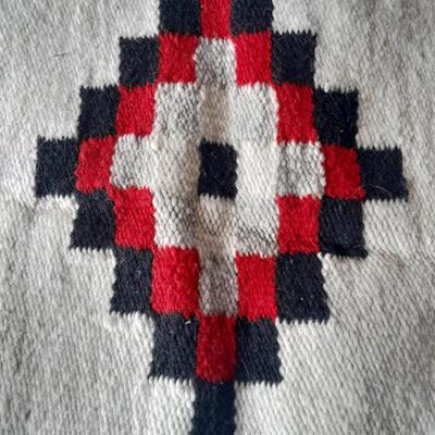 Pacific pottery vase with Native American print table throw.