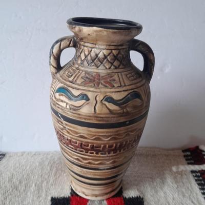 Pacific pottery vase with Native American print table throw.