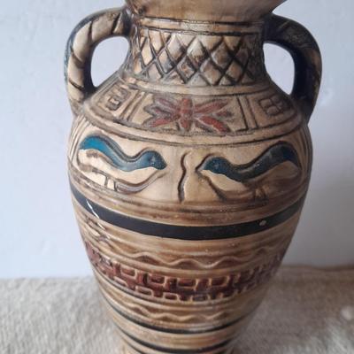Pacific pottery vase with Native American print table throw.