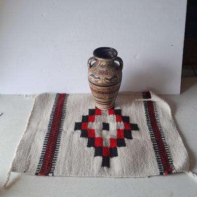 Pacific pottery vase with Native American print table throw.