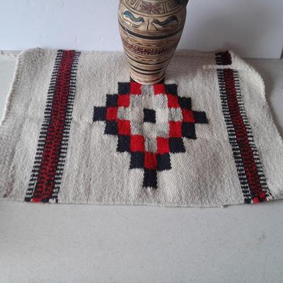 Pacific pottery vase with Native American print table throw.