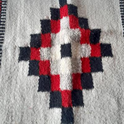 Pacific pottery vase with Native American print table throw.