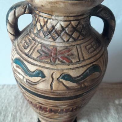 Pacific pottery vase with Native American print table throw.