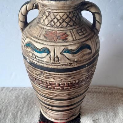 Pacific pottery vase with Native American print table throw.
