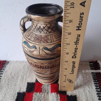 Pacific pottery vase with Native American print table throw.