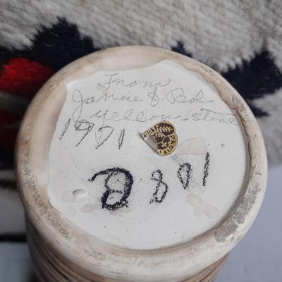 Pacific pottery vase with Native American print table throw.