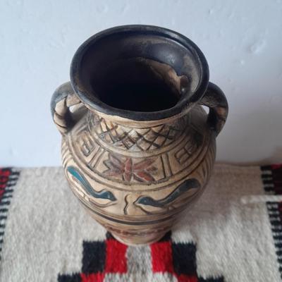 Pacific pottery vase with Native American print table throw.