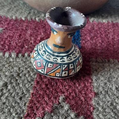 Pottery vase with pottery decor, and a woven Multi Color Durrie