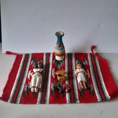 Signed pottery vase with Native dolls and Native. table throw rug