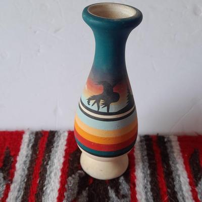 Signed pottery vase with Native dolls and Native. table throw rug