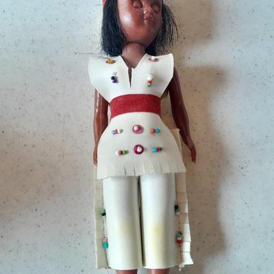 Signed pottery vase with Native dolls and Native. table throw rug