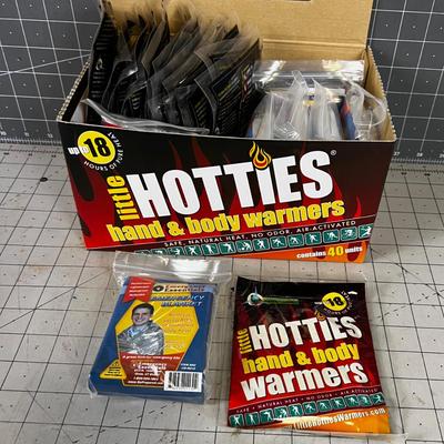 Box full of Space Blankets and Hotties Hand Warmers 