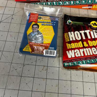 Box full of Space Blankets and Hotties Hand Warmers 