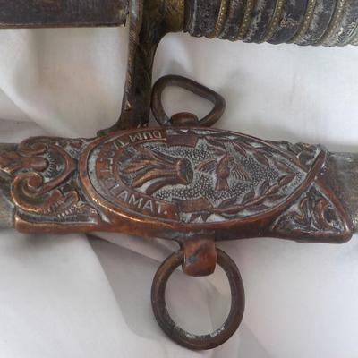 The Woodsman of the World sword and metal scabbard. /est. $100 to $200.