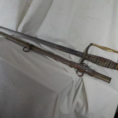 The Woodsman of the World sword and metal scabbard. /est. $100 to $200.