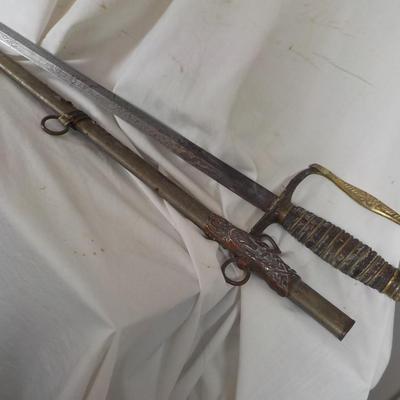The Woodsman of the World sword and metal scabbard. /est. $100 to $200.