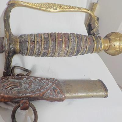 The Woodsman of the World sword and metal scabbard. /est. $100 to $200.