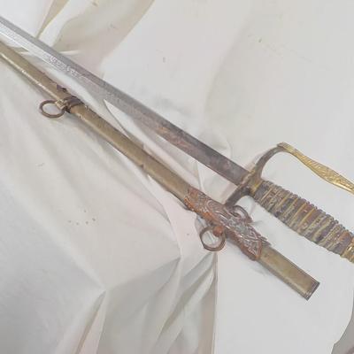 The Woodsman of the World sword and metal scabbard. /est. $100 to $200.