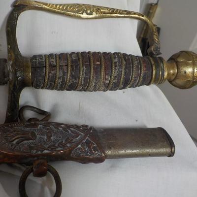 The Woodsman of the World sword and metal scabbard. /est. $100 to $200.