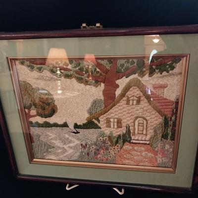 FRAMED NEEDLEPOINT PICTURE WITH A PAIR OF GLASS CANDLESTICKS