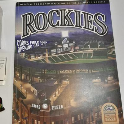 Rockies 1995 Coors Field ball, Rockies opening day scorecard magazine, collectors' pins and large matted ticket.