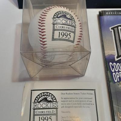 Rockies 1995 Coors Field ball, Rockies opening day scorecard magazine, collectors' pins and large matted ticket.