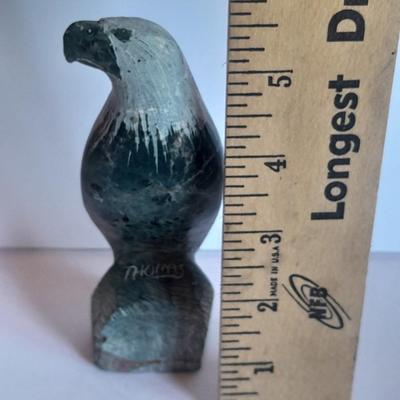 Signed stone Eagle statue with Zuni fetish pot cased in turquoise chips with feather accents.