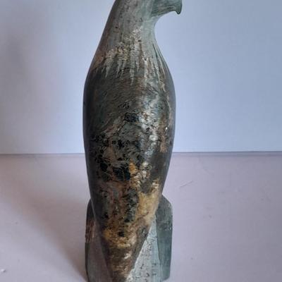 Signed stone Eagle statue with Zuni fetish pot cased in turquoise chips with feather accents.