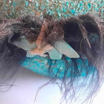 Signed stone Eagle statue with Zuni fetish pot cased in turquoise chips with feather accents.