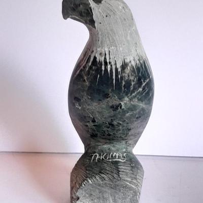 Signed stone Eagle statue with Zuni fetish pot cased in turquoise chips with feather accents.