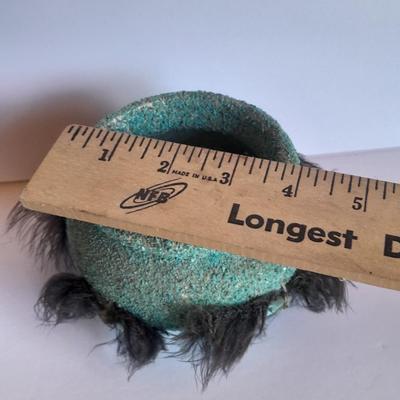 Signed stone Eagle statue with Zuni fetish pot cased in turquoise chips with feather accents.