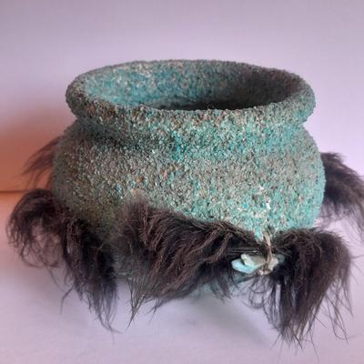 Signed stone Eagle statue with Zuni fetish pot cased in turquoise chips with feather accents.