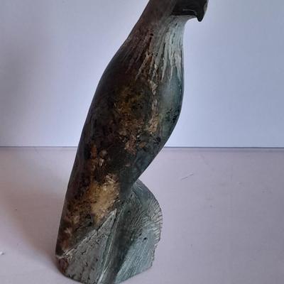 Signed stone Eagle statue with Zuni fetish pot cased in turquoise chips with feather accents.