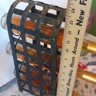 Metal wine rack with stemmed glasses and wine decor
