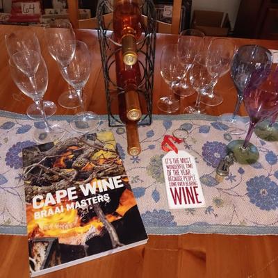 Metal wine rack with stemmed glasses and wine decor