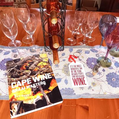 Metal wine rack with stemmed glasses and wine decor