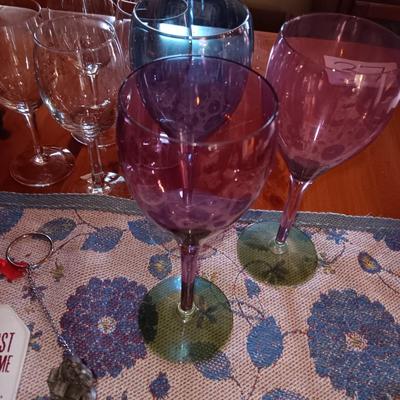 Metal wine rack with stemmed glasses and wine decor