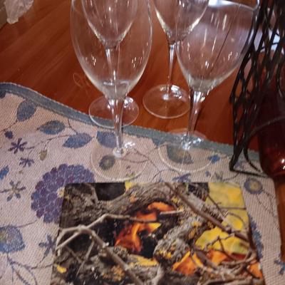 Metal wine rack with stemmed glasses and wine decor