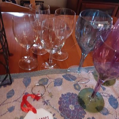 Metal wine rack with stemmed glasses and wine decor