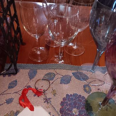 Metal wine rack with stemmed glasses and wine decor